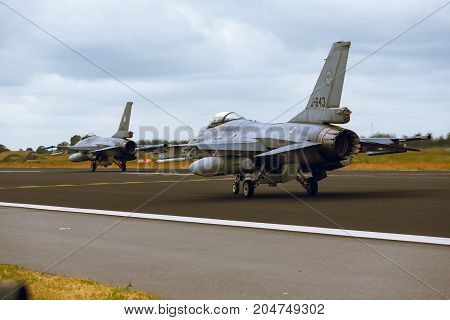 Schleswig - Jagel Germany - June 19 2014: Two Netherlands - Air Force General Dynamics F-16A Fighting Falcon is taxiing on strip of airbase Schleswig - Jagel during NATO Tiger Meet 2014.