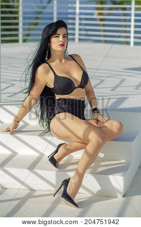 Sexy latina with long black hair in black lingerie