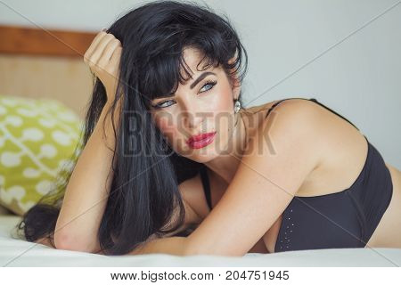 Sexy latina with long black hair in black lingerie