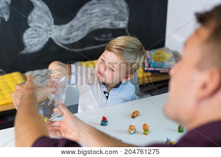 Cute little playfull toddler boy at child therapy session. Private one on one homeschooling with didactic aids.