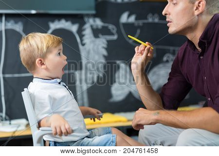 Cute little boy at speech therapist session. Private one on one homeschooling.