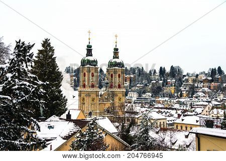 St Gallen, Switzerland. Aerial view of historical buildings covered in snow in winter. Cathedral in St Gallen, Switzerland with bright blue sky