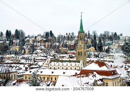 St Gallen, Switzerland. Aerial view of historical buildings covered in snow in winter. Cathedral in St Gallen, Switzerland with bright blue sky