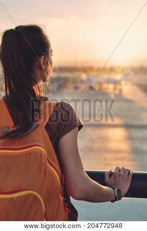 Girl at the airport window looking outside