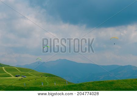 Skydivers in the sky over the Caucasus Mountains, Georgia.
