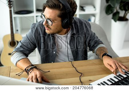 young sound producer working with MPC pad