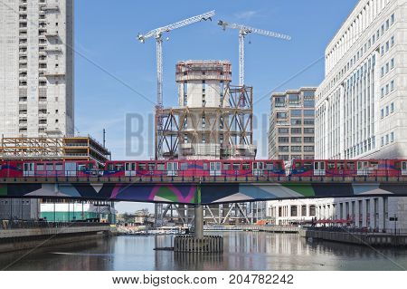 London England - August 13 2017: Overground DLR train approaches Canary Wharf DLR station in London Stock Exchange district.