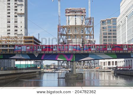 London England - August 13 2017: Overground DLR train approaches Canary Wharf DLR station in London Stock Exchange district.