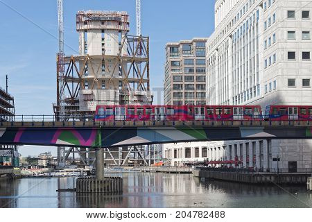 London England - August 13 2017: Overground DLR train approaches Canary Wharf DLR station in London Stock Exchange district.