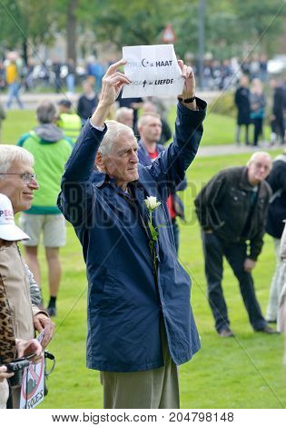 ENSCHEDE THE NETHERLANDS - SEPT 17 2017: An old man is protesting during an anti islam demonstration of Pegida. Pegida is a group of people who are against the islamization of Europe.