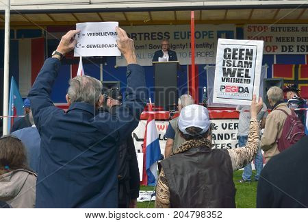 ENSCHEDE THE NETHERLANDS - SEPT 17 2017: People are protesting during an anti islam demonstration of Pegida. Pegida is a group of people who are against the islamization of Europe.