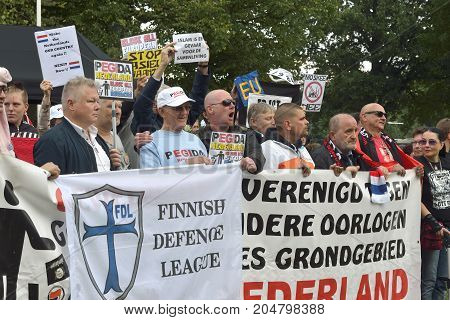 ENSCHEDE THE NETHERLANDS - SEPT 17 2017: People are protesting during an anti islam demonstration of Pegida. Pegida is a group of people who are against the islamization of Europe.