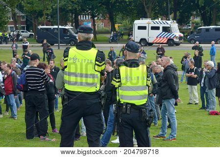 ENSCHEDE THE NETHERLANDS - SEPT 17 2017: Police taking care of security during an anti-islam gathering of Pegida. Pegida is a group of people who are against the islamization of Europe.