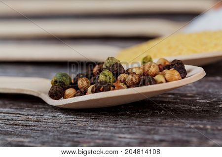 Powder Spices On Spoons In Black Wooden Table