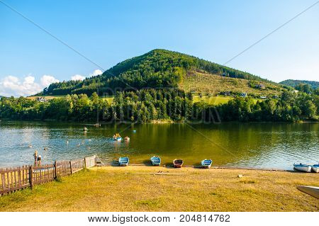 Summer at Bystricka dam with small boat and pedal booms, Moravia, Czech Republic.
