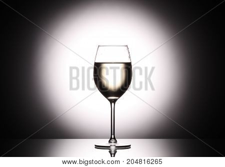 Wineglass With White Wine - Transperent Liquid - On Studio Background.