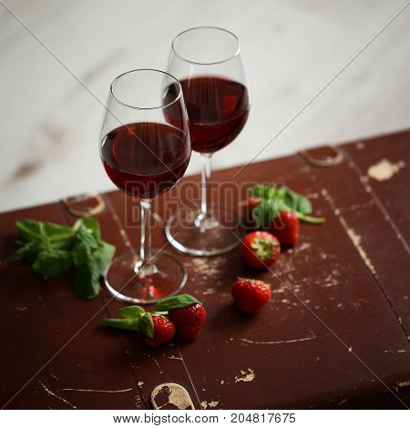 Wineglasses With Red Wine Decorated With Strawberry And Mint