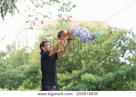 Warsaw, Poland - August 2, 2017: Dad And His Son Spend Time In The City Park.