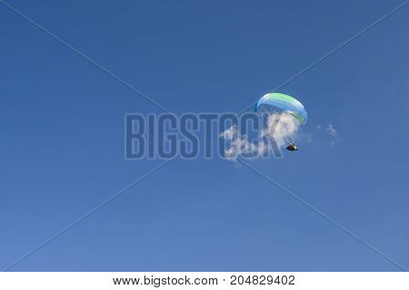 Skydiver in the clouds. Bright sports background