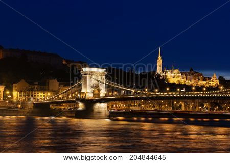 Beautiful night Budapest, the Chain bridge across the Danube river in lights with dark blue sky, Travel outdoor sightseeing european background.