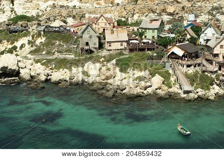 Papay village on Malta, old wooden houses and blue sea