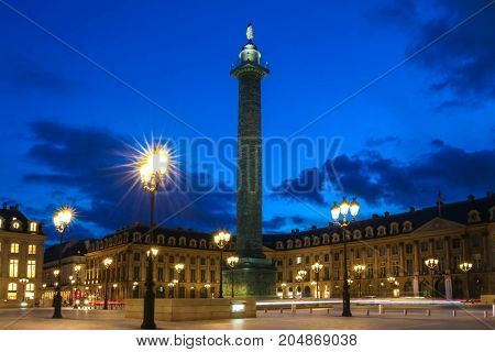 Vendome column with statue of Napoleon Bonaparte, on the Place Vendome at night, in France. Vendome column has 425 spiraling bas-relief bronze plates were made out of cannon.