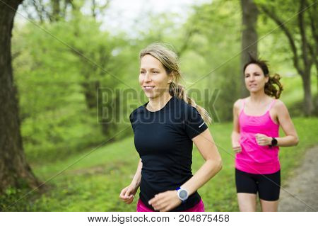 Two Beautiful Female runner outside having fun
