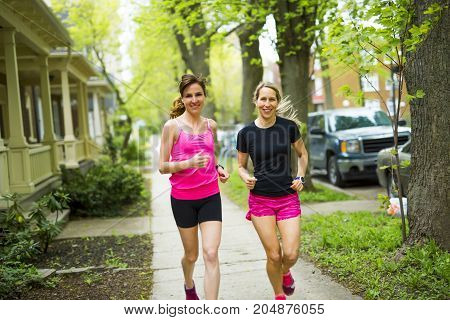 Two Beautiful Female runner outside having fun