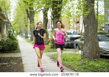 Two Beautiful Female runner outside having fun