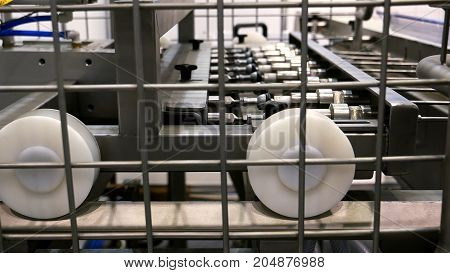 Food factory automated robotic production machine. Conveyor product line for cooking and packing rations and foods. Robotics and automatic lines used instead of human labor on factories and plants.