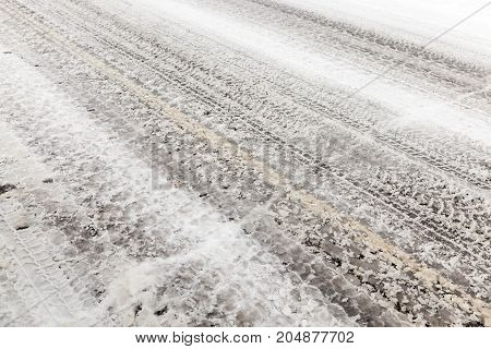 Small Rural Road Covered With Snow. The Photo Was Taken Close. On The Roadway Vision Dirt Strip On C