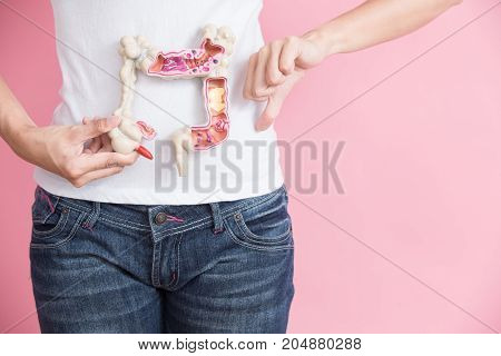 woman with colorectal cancer concept on the pink backgorund