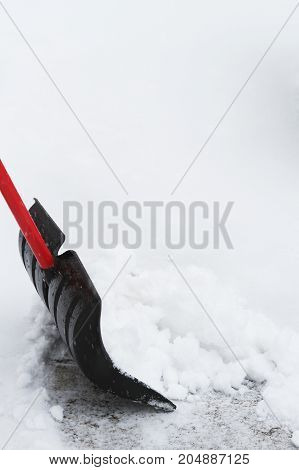 a snow shovel in the drive way.