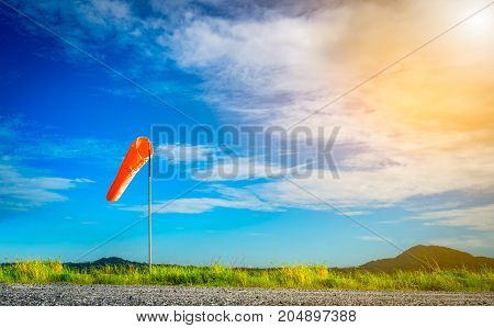 Wind sock on a pole with beautiful sky.