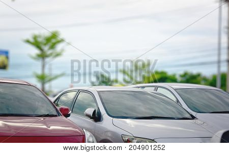 Car parked on the street.Cars parked inside the parking lot.