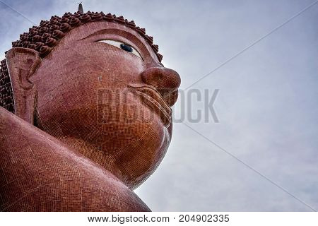 The big Buddha image in Thai temple at Nakhon prathom. See the blue sky and clouds are on background looking so beautiful.