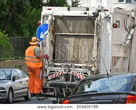Garbage truck on the street in summer