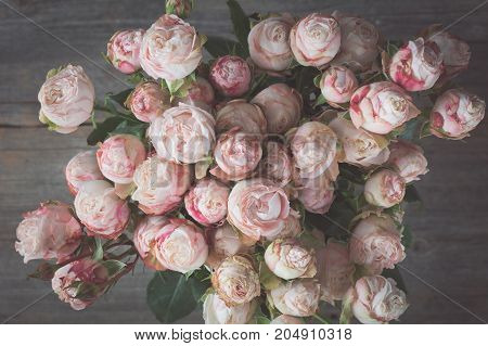 Wedding bouquet of pink roses retro style. Closeup view, toned image, selective focus