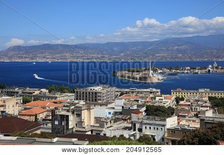 Port of Messina with the gold Madonna della Lettera statue. Sicily. Italy