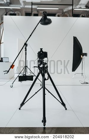 Camera In Photo Studio With Lighting Equipment