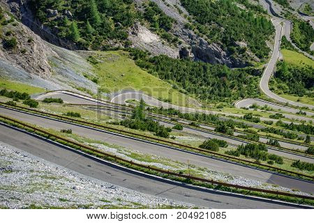 Top view of serpentine road and galleries of Stelvio Pass from above. Bormio side
