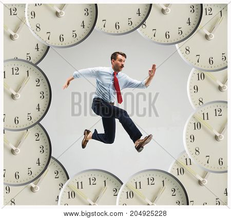 Businessman running over alarm clock. Collage about tardiness and lack of time. concept of business acceleration