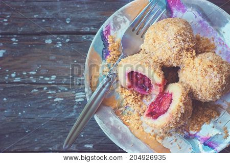 Top view of a colorful plate with plum dumplings