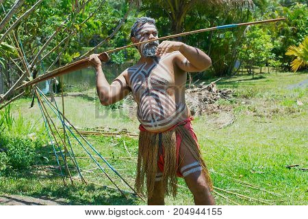 KURANDA, AUSTRALIA - NOVEMBER 07, 2007: Unidentified aborigine actor throws a spear in the Tjapukai Culture Park in Kuranda, Queensland, Australia.
