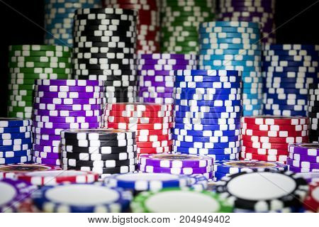 Stack of Poker chips on a green gaming poker table at the casino. Poker game concept. Playing a game with dice. Casino Concept for business risk chance good luck or gambling. chips for poker game