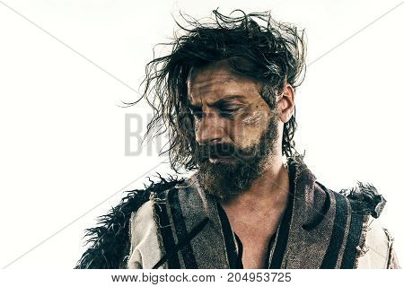 Portrait of a brutal bald-headed viking in a battle isolated against a white background. Early medieval period. Actor in makeup. concept of vagrancy and survival