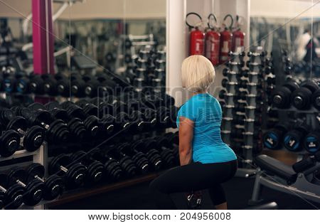 Bodybuilding. Strong Fit Female Exercising With Weight. Blond Girl Lifting Weights In Gym. Strong Wo
