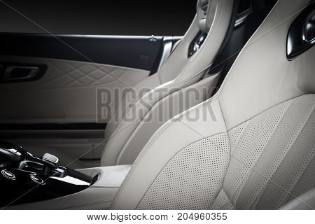 Race seats in modern luxury car, frontal view, white leather, clipping path for windows included