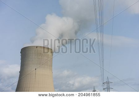 Cooling tower of nuclear power plant against the blue sky
