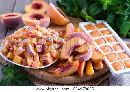 Frozen peaches on a wooden table. Frozen food